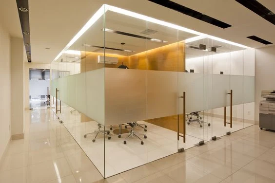 Frameless glass office partitions in a modern Dubai workplace.