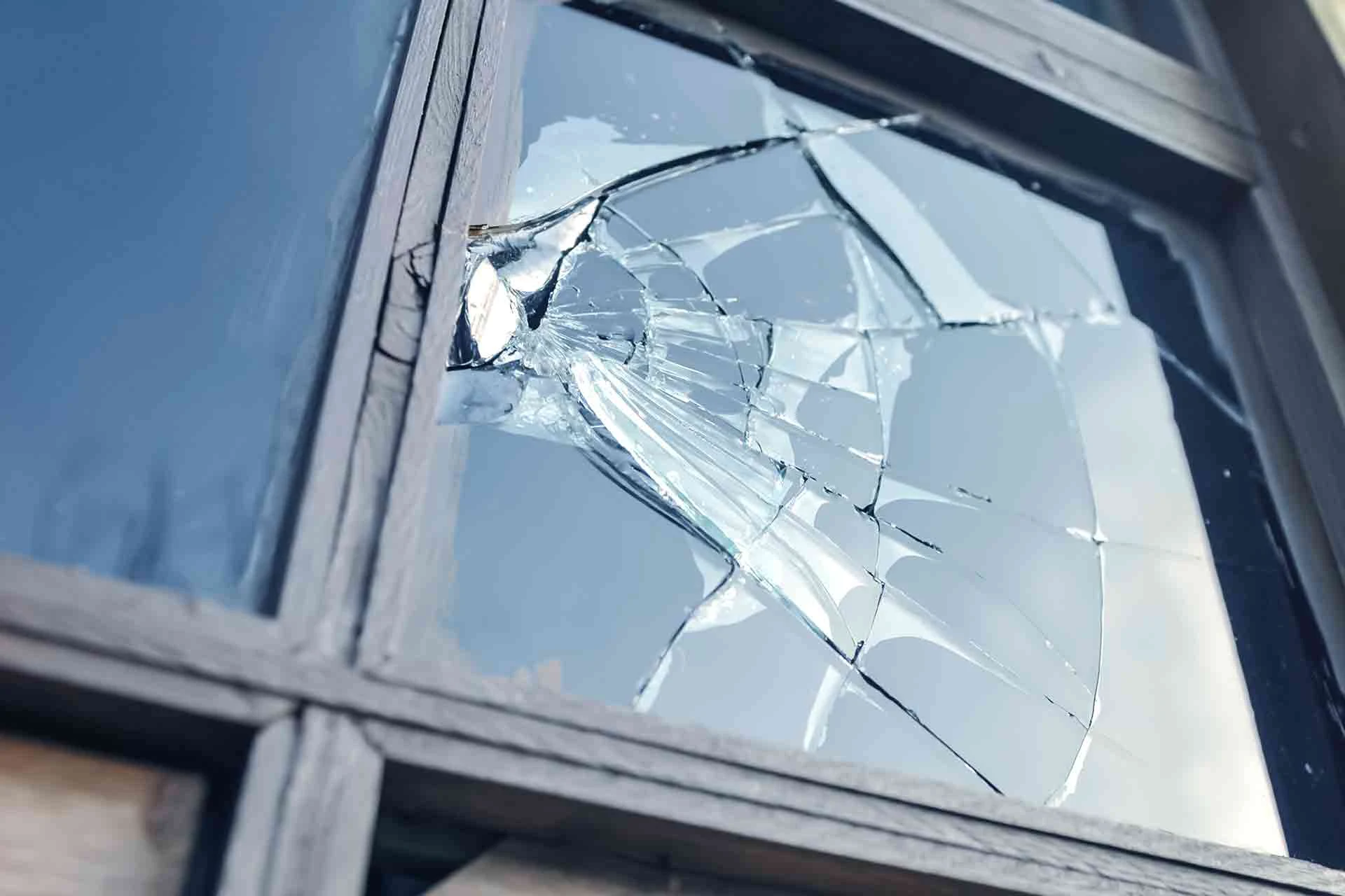 Broken window glass requiring replacement.