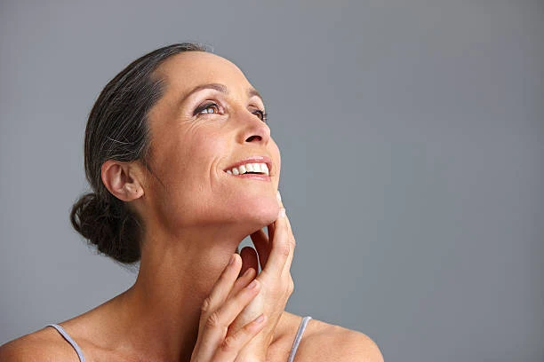 Woman touching the skin of her neck