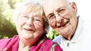 Smiling elderly couple together.
