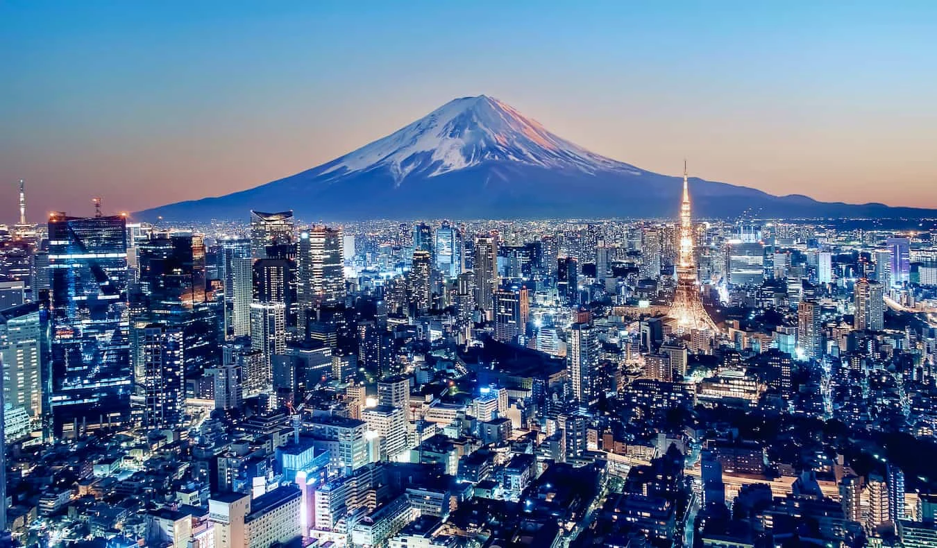 Tokyo skyline illuminated at blue hour with Mount Fuji in the distance