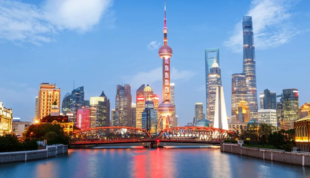 Shanghai skyline and riverfront illuminated at dusk