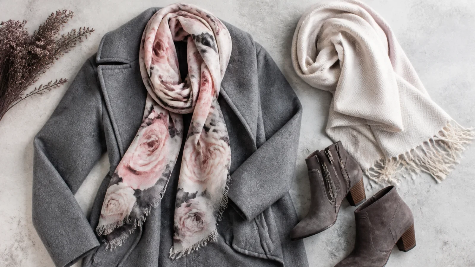 Gray winter coat, rose-pattern scarf, boots, and a light shawl.